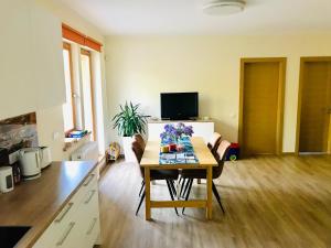 a living room with a table and a kitchen at Family apartment 100m from the beach in Jūrmala