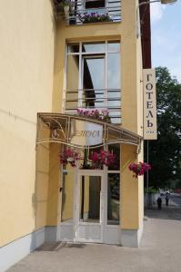 a building with flowers on the front of it at Etna Hotel in Lviv