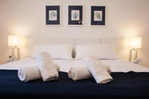a large white bed with two pillows on it at New Opening Villa Oasis Terramar in Sitges