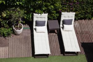 two white pillows and a table on a patio at New Opening Villa Oasis Terramar in Sitges