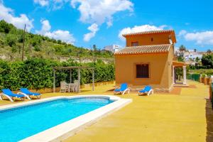 a villa with a swimming pool and a house at Marques - holiday home with private swimming pool in Benitachell in Benitachell
