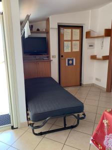 a room with a blue bench in a room with a tv at Mansarda 25 in Terracina