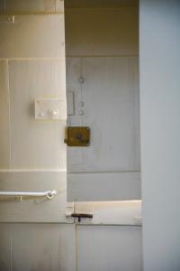 a mirror on a wall in a bathroom at Kleio House in Astypalaia Town