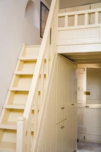a staircase in a house with a closet under it at Kleio House in Astypalaia Town