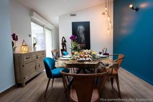 a dining room with a table with food on it at La Parenthèse des Capucins - Maison d'hôtes Bordeaux in Bordeaux