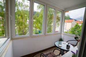 a room with windows and a table and a table at ROMANTIK APARTMENTS in Câmpulung Moldovenesc