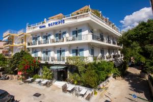 a large white building with a balcony at Olympic Hotel in Parga
