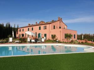 a large house with a swimming pool in front of a house at My Tuscany Suites in Castiglioncello