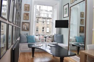 a living room with a couch and a table at Frederick Street - stylish apartment in the heart of New Town! in Edinburgh