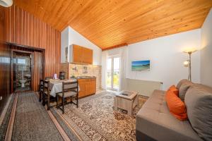 a living room with a couch and a table and a kitchen at Apartments Klavdija in Vodice