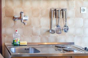 a kitchen counter with a sink and utensils at Apartments Klavdija in Vodice +33 photos