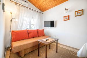 a living room with a couch and a table at Apartments Klavdija in Vodice