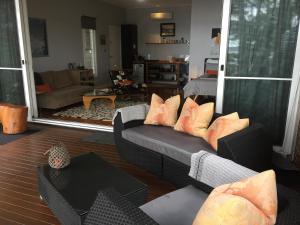 a living room with a couch with pillows at Smiths Lake House in Smiths Lake