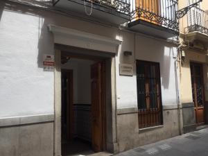 a building with an open door and a balcony at Residencia Jardines in Granada