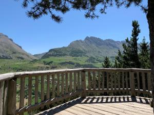 a wooden deck with a view of mountains at Appartement Superdevoluy Le Petit Suisse in Le Dévoluy +8 photos