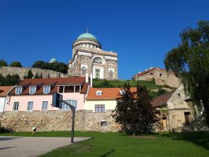 a building with a clock tower on top of a hill at Sasi Panzió 1 in Esztergom