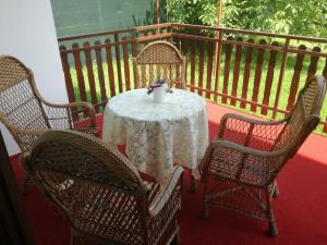 a table with chairs and a white table cloth on a balcony at Holiday Home Iman in Sarajevo
