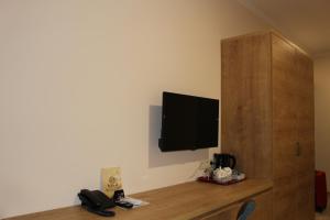 a room with a wooden floor and a television on the wall at Boutique Hotel 32 in Batumi