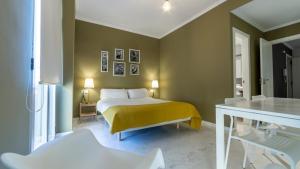 a bedroom with a bed with a yellow blanket at La Morella del Carmen in Valencia