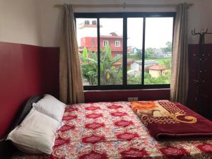 a bedroom with a bed with a large window at Om sweet Home ॐ in Pokhara