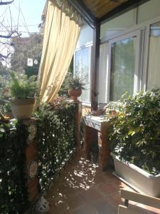 a patio with a curtain and some potted plants at Casa donna Fiorella tipica siciliana in Taormina