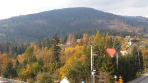 a town in the middle of a mountain with trees at Willa Potoczki in Istebna