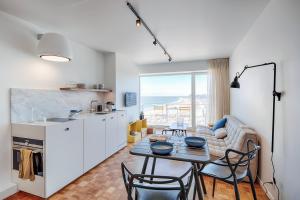 een keuken en een woonkamer met een tafel en stoelen bij knokkeappart Studio 2 pers in Knokke-Heist
