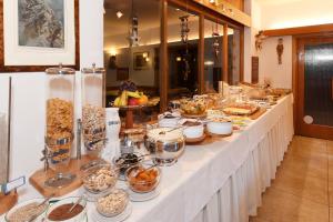 a buffet line with many food items on it at Hotel Garni Vanadis in Ortisei