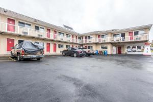 a parking lot in front of a large building at Lake City Motel in Halifax