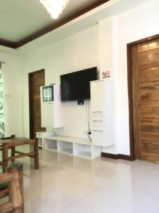 a living room with a flat screen tv on a wall at Homaja Roomrental in Panglao