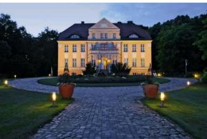 a large house with lights in front of it at Ferienapartment Wiese & Meer auf Rügen in Neddesitz