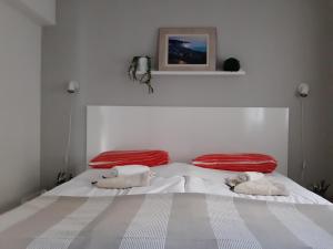a white bed with two pillows on top of it at Beach Apartment More in Seget Vranjica