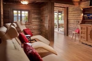 a living room with wooden walls and couches at Prinz-Luitpold-Bad in Bad Hindelang