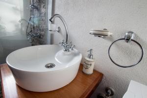 a bathroom with a white sink on a wooden table at Banjo Rustic House Lake view in Virpazar