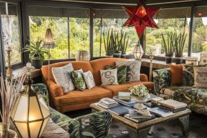 a living room with a couch and a table at Hotel Villa Carlotta in Taormina