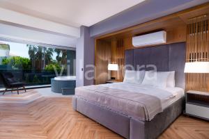 a bedroom with a large bed and a large window at Villa Hera Hisaronu/ Oludeniz/ Fethiye in Fethiye