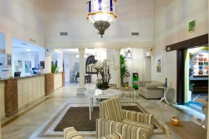 a living room with a lobby with a table and chairs at Ona Alanda Club Marbella in Marbella