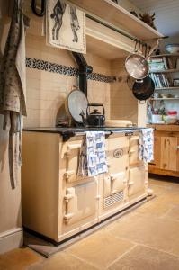 a kitchen with a stove and a counter top at Milton Farm in East Knoyle