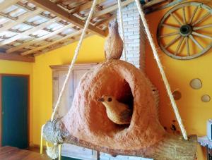 a bird house with a bird inside of it at Pousada Luz do Sol in Carrancas