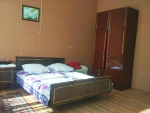 a bedroom with a bed and a dresser at Guest House Knarik in Jvari