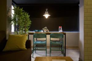 a kitchen with two chairs and a counter with a table at Suite Loc Suite & Spa in Casablanca