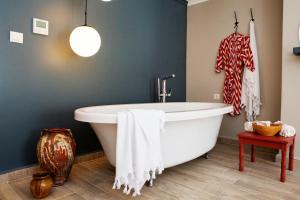 a bathroom with a large white tub in a room at Suna Sun Hotel - Adult Only in Kaş