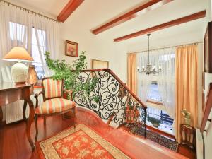 a living room with a staircase and a chair at Rancho Willa & Restaurant in Rewal
