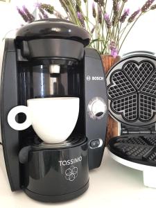 a coffee maker with a cup on top of it at Greekowl apartments in Skiathos +29 photos