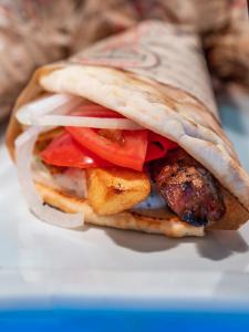 a sandwich with meat and vegetables on a bagel at Paleokastritsa Palace - Adults Only in Paleokastritsa