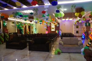 a banquet hall with couches and balloons in a room at HOTEL SHIVOY GRAND in Varanasi +61 photos