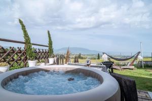 a hot tub on a patio with a view at Casa Vog in Brufa