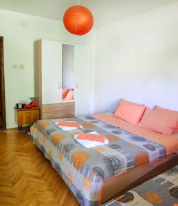 a bedroom with a large bed with pink pillows at Central Studios & Rooms in Ohrid