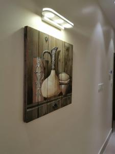 a painting of two vases on a wall at Alwan apartment hotel in Khamis Mushayt
