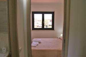 Postel nebo postele na pokoji v ubytování Portoada Park Villas